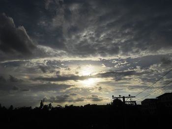 Low angle view of silhouette trees against sky during sunset