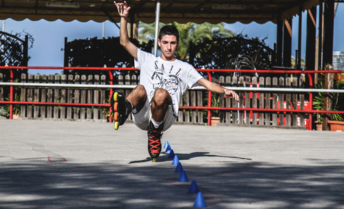 Full length of young man inline skating