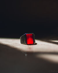 Close-up of heart shape on table against black background