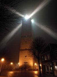 Low angle view of illuminated street light at night