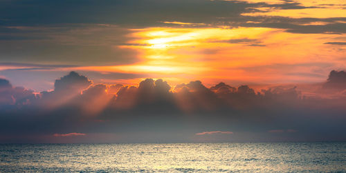 Scenic view of sea against sky during sunrise.