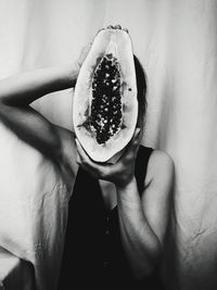 Close-up of woman holding papaya