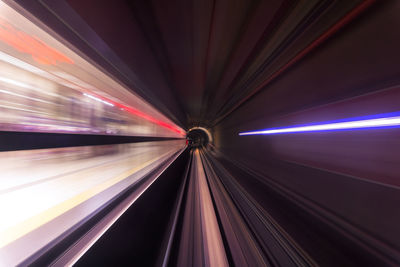 Light trails on illuminated bridge at night