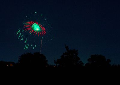 Low angle view of firework display at night