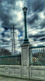 Low angle view of eiffel tower against cloudy sky
