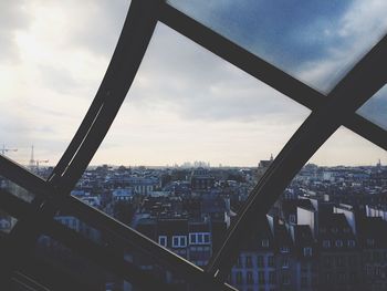 Cityscape against cloudy sky