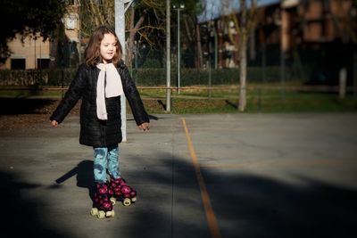 Full length of girl roller skating at park