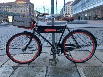 Bicycle parked on street by building