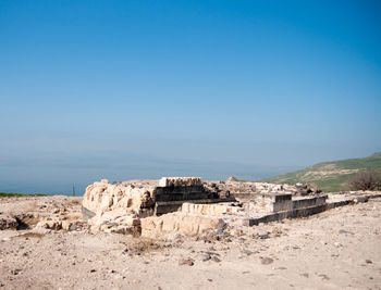 Built structure on land against clear blue sky