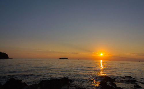 Scenic view of sea against sky during sunset