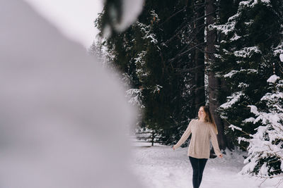 Woman standing on snow covered land