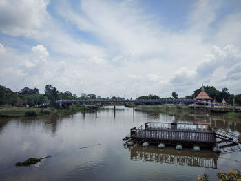 Scenic view of river by building against sky