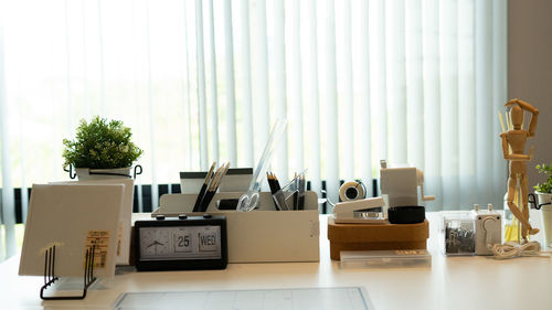 Potted plants on table against modern building