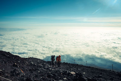 Panoramic view of people on mountain against sky