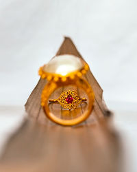 Close-up of gold colored pencils on table