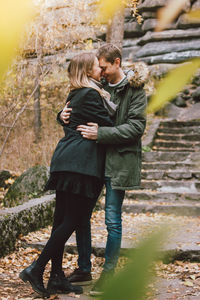 Happy couple embracing on steps in park