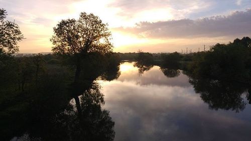 Reflection of clouds in lake at sunset