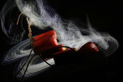 Digital composite image of illuminated table against black background