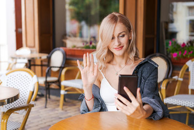 Young woman using mobile phone in cafe