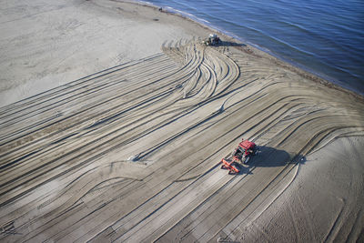 High angle view of tractors on sand at beach