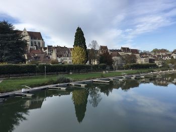 The notre-dame de dole church and the old town seen from the canal port in dole, france