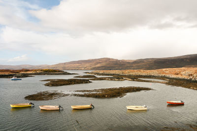 Line of coloured boats in lake