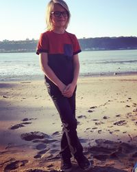 Man standing on beach against sky