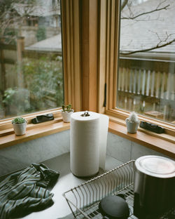 Modern kitchen countertop with paper towel holder by windows on steel