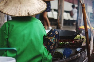 Rear view of man selling food at market