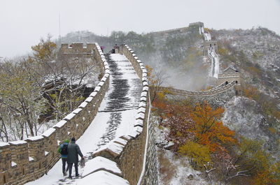 Hikers walking at great wall of china during winter