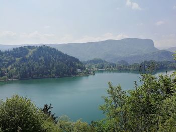 Scenic view of lake and mountains against sky