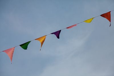 Low angle view of flags against sky