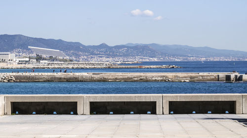 Scenic view of sea by city against sky