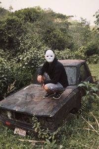 Man sitting on old vehicle