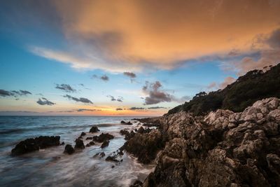 Scenic view of sea against sky at sunset