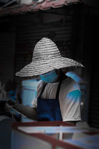 Rear view of a woman sitting with umbrella