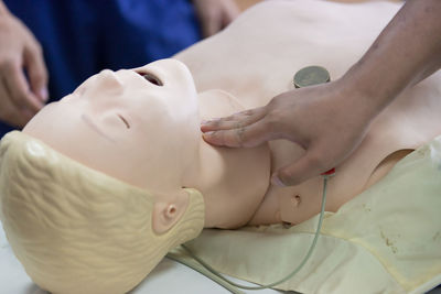 Cropped image of person learning cpr in hospital