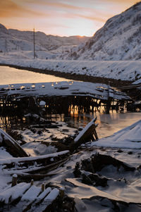 Scenic view of snow covered mountains against sky during sunset