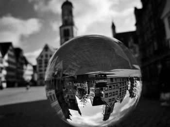 Digital composite image of crystal ball and buildings in city