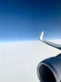 Airplane flying against clear blue sky