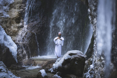 Full length of woman standing on rock