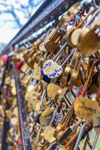 Close-up of love locks hanging on railing