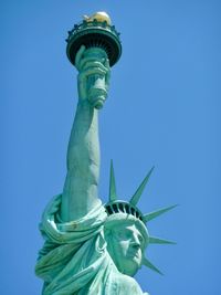 Statue of liberty against blue sky