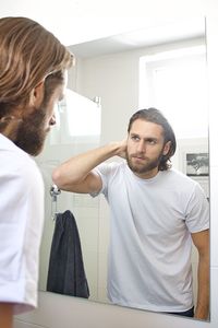 Bearded young man at domestic bathroom