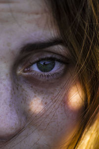 Cropped portrait of young woman with freckles