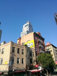 Low angle view of buildings against clear blue sky