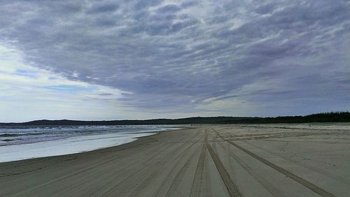 Scenic view of sea against cloudy sky