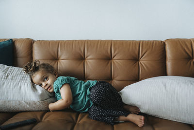 Portrait of girl lying on sofa and relaxing