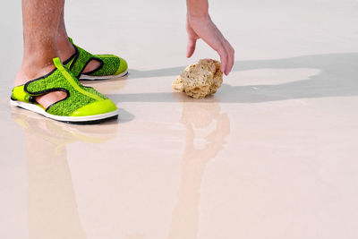 Low section of person standing on cutting board