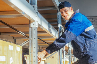 Portrait of young woman standing in building